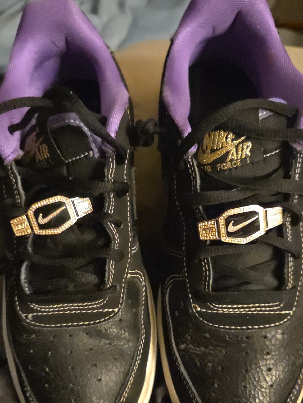 Nike Kids Black Sneakers with Purple Lining and Gold Accents